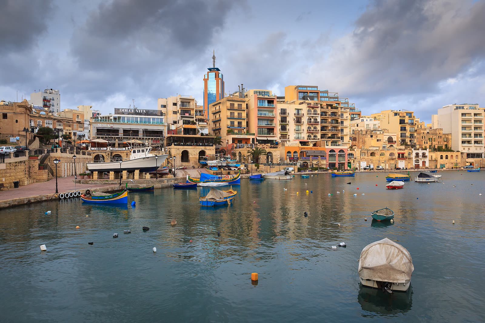 Luzzu boats moored in Spinola Bay, St Julian's, Malta